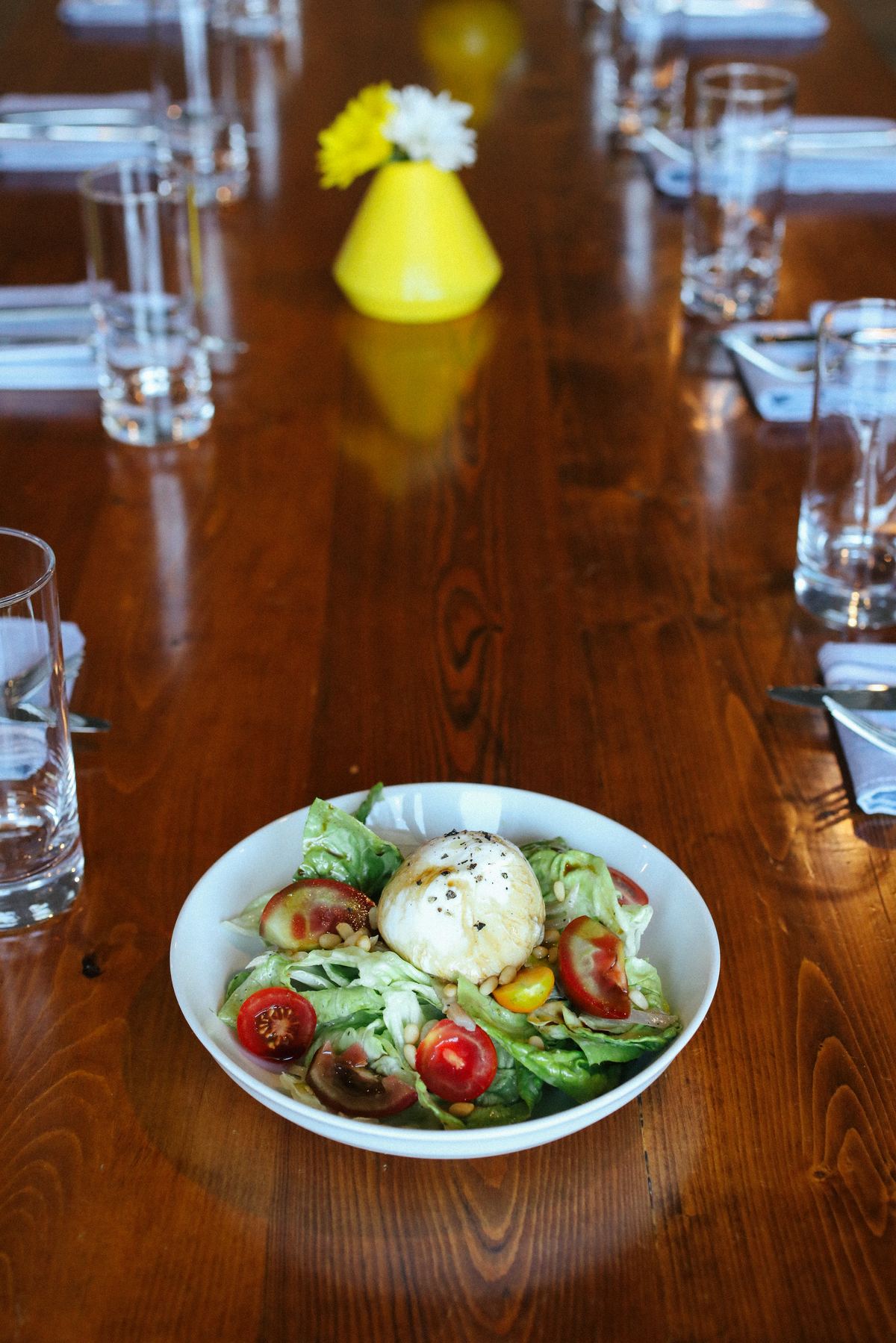 Amici cocktail and salad on a dining table