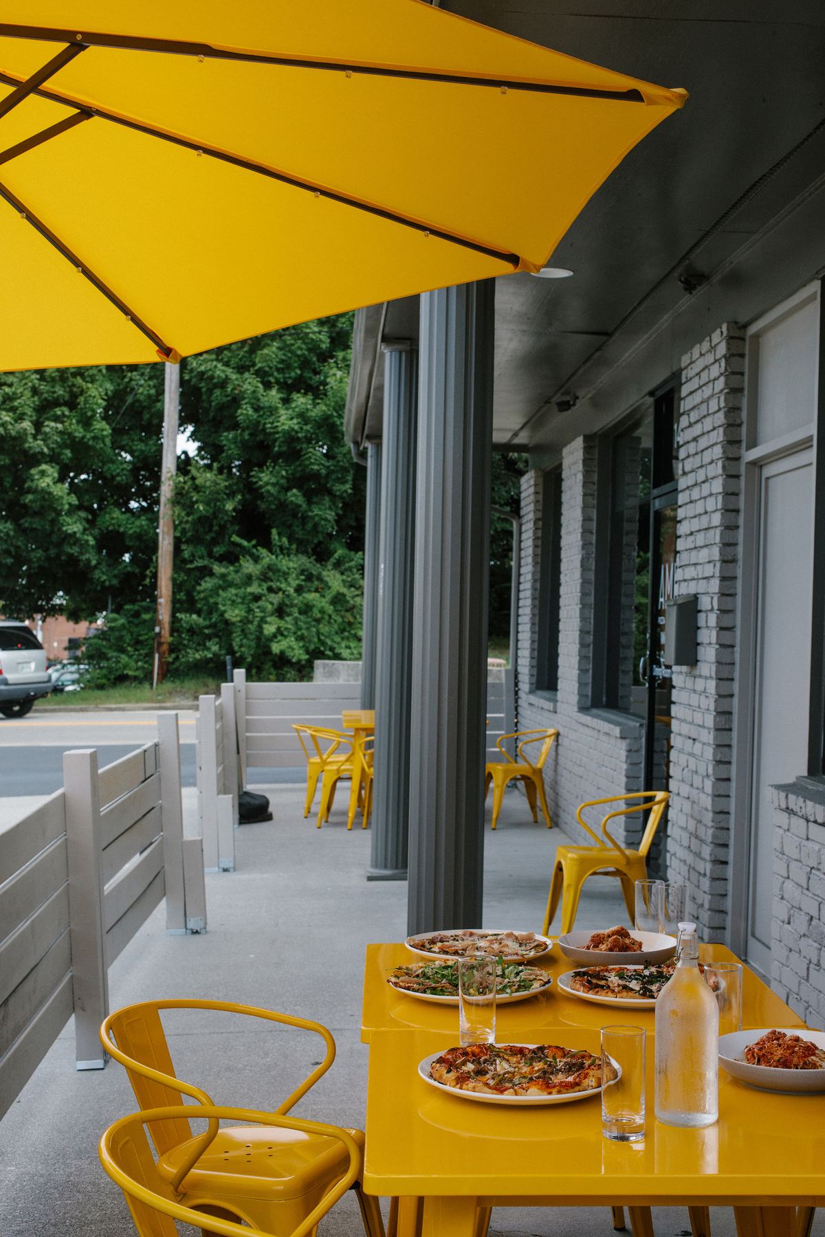 Yellow patio tables outside Amici Maryville